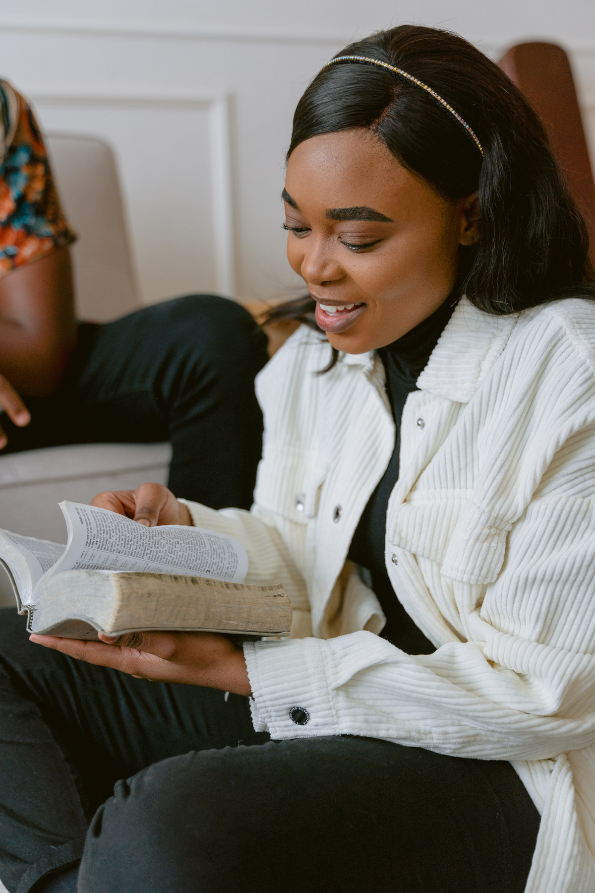 Woman in White Jacket Reading the Bible